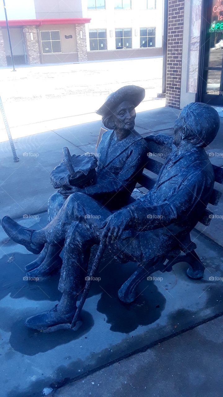 Old Couple Sitting On Bench Statue