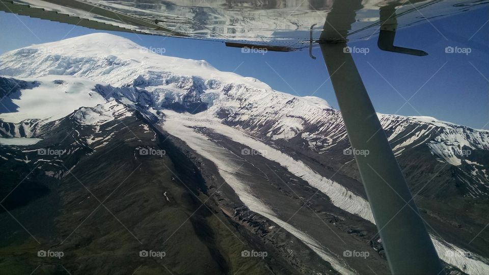 flying over glacial flows back side of Mt Sanford, Alaska