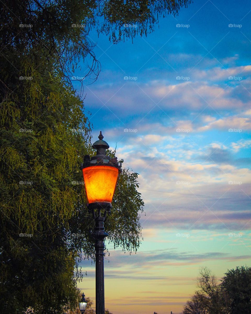 Side view of an antique street lamp in the evening.   Calm down day