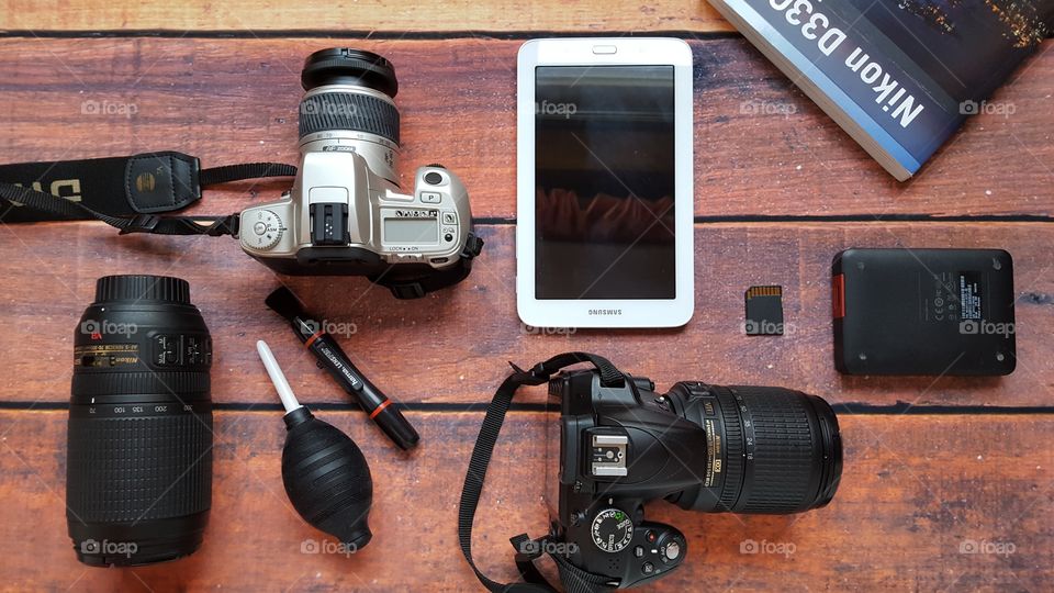 Photography equipment on a wooden desk.