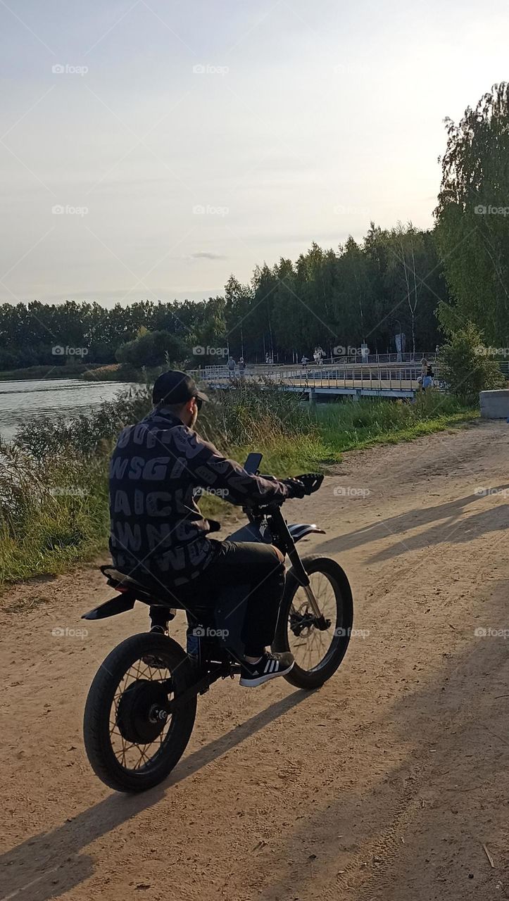 men on a electric motorcycle, summer time