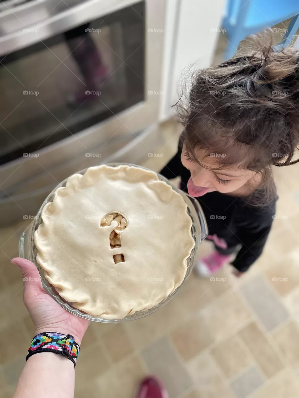 Toddler trying to eat pie on its way to the oven, toddler excited about pie, making apple pies with toddlers, delicious apple pie, baking pies at home
