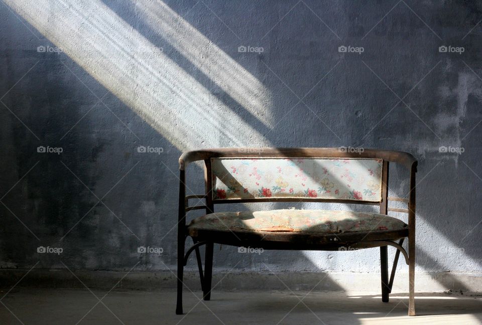 Sunbeam indoor, empty bench in the room, light on it