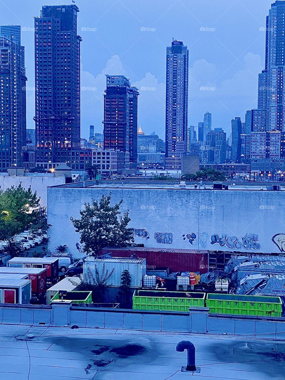 This is a view from the staircase to the “Pulaski Bridge” at “Newtown Creek” in LIC, Queens overlooking LIC skyscrapers and high rises. Further into the distance you can see “Manhattan”. 2023. Hypnotic Productions