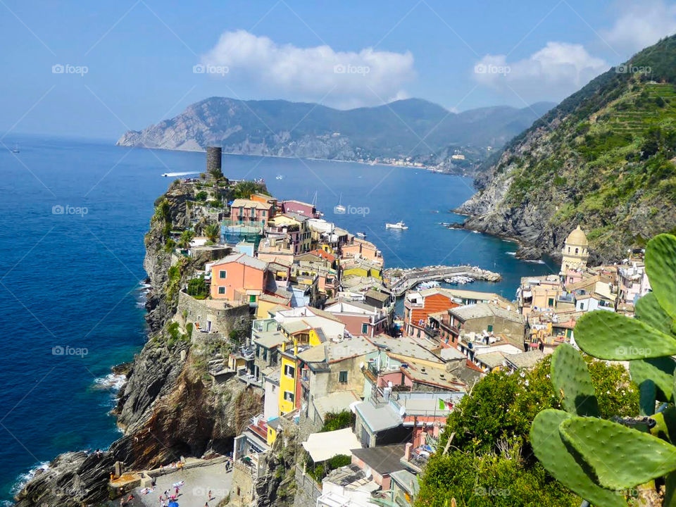 Colourful houses perched on a cliff overlooking the sea in Cinque Terre