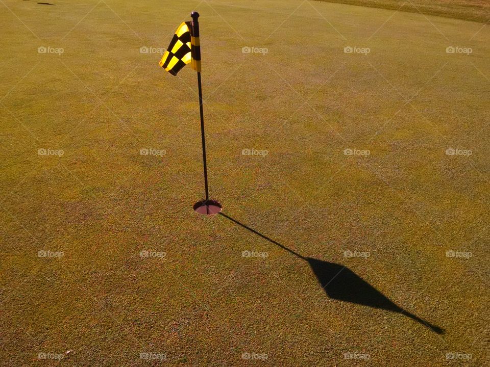 golf hole in morning sun