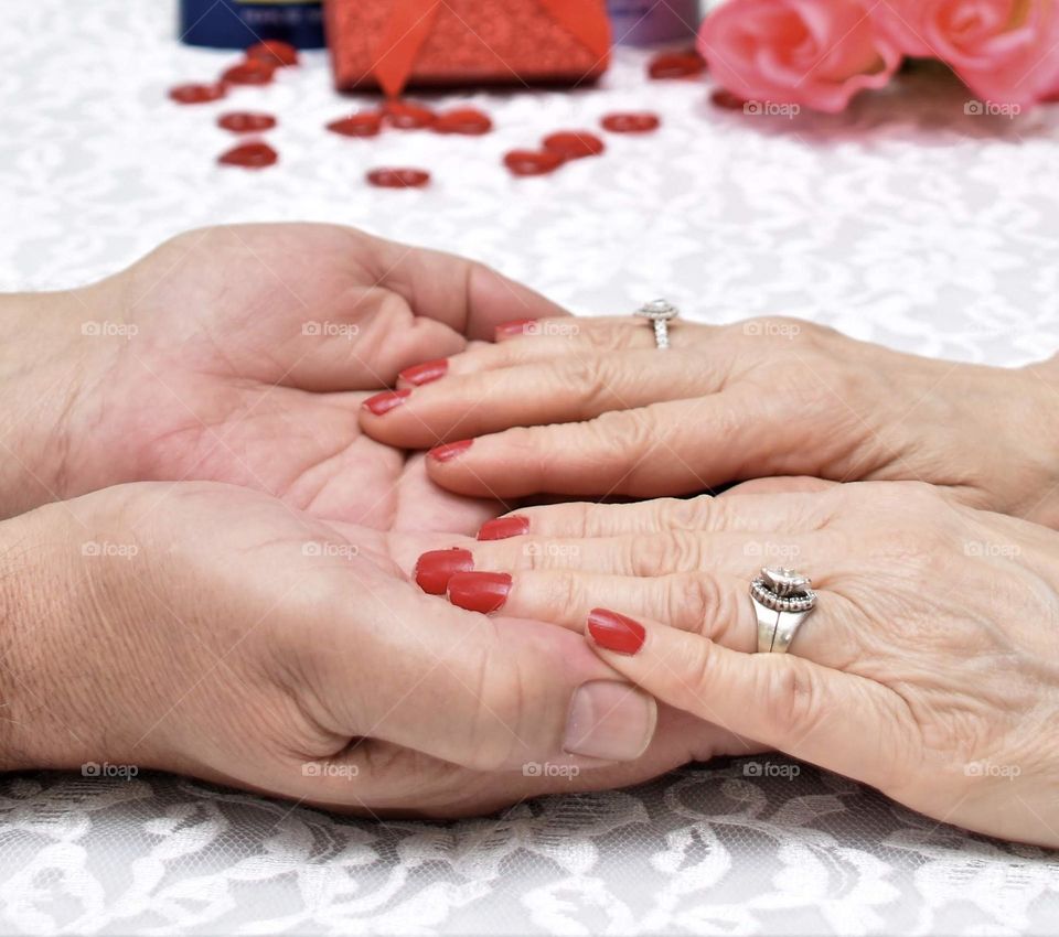 Still in love after all these years, older couple hands