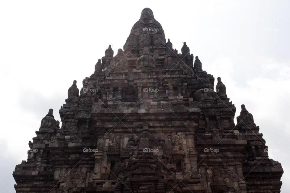 One of the temples in the Prambanan Temple Complex, with a stone relief on the wall of the temple which is part of the largest Hindu temple in Southeast Asia, Yogyakarta, Indonesia - June 23, 2023