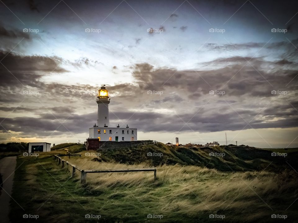 An artistic view of Flamborough head lighthouse with windswept wild grass in flamborough, UK. 