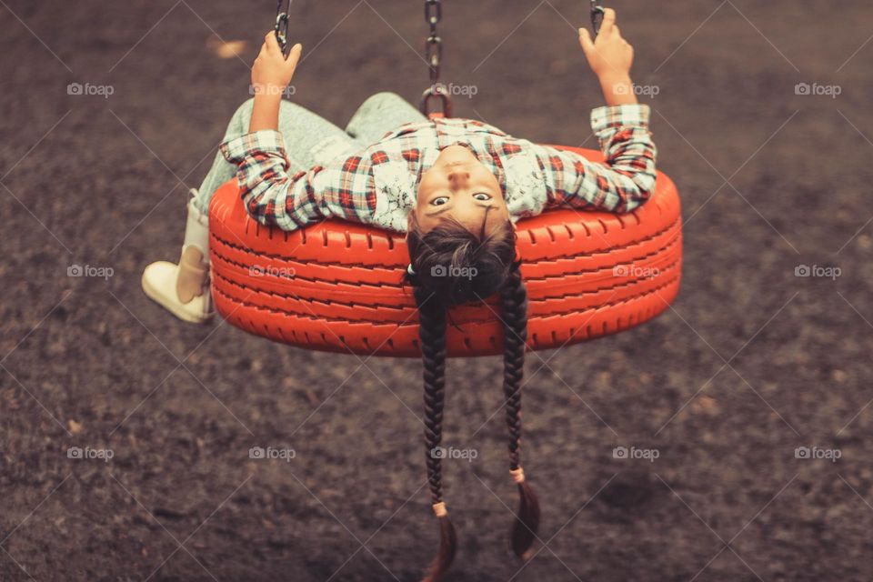 Sad girl on a swing