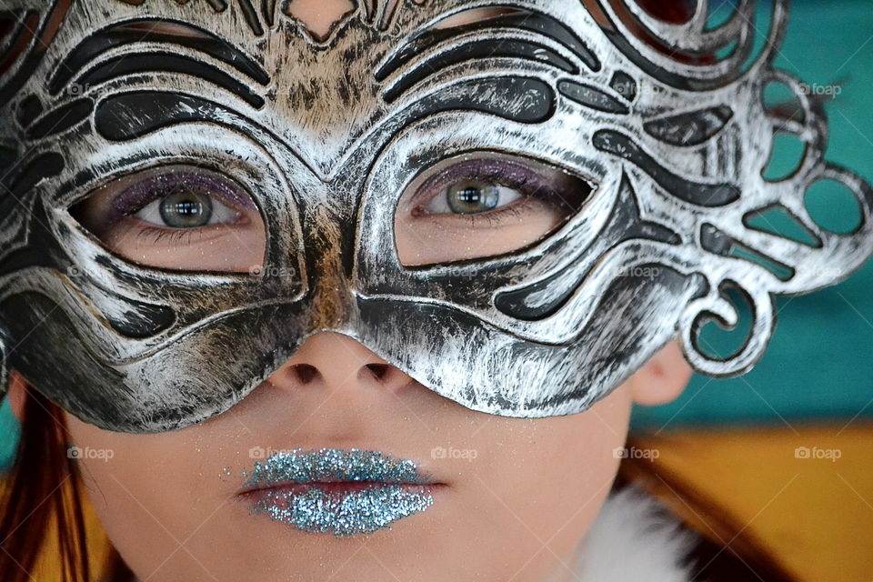 Beautiful woman makeup with wearing glitter and mask