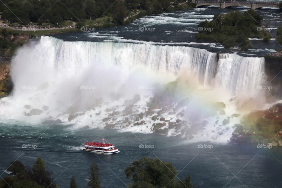 Misty Boat ride from American Falls to the Canadian Horseshoe Falls with view of beautiful rainbow