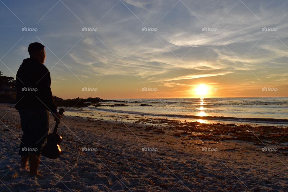 Sunset days at the beach playing the ukulele