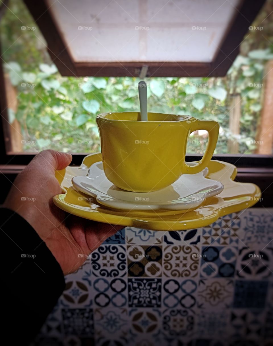 yellow cup in the window