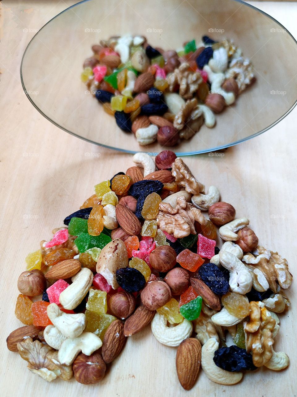 Reflection of nuts and dried fruits in the form of a heart in the mirror