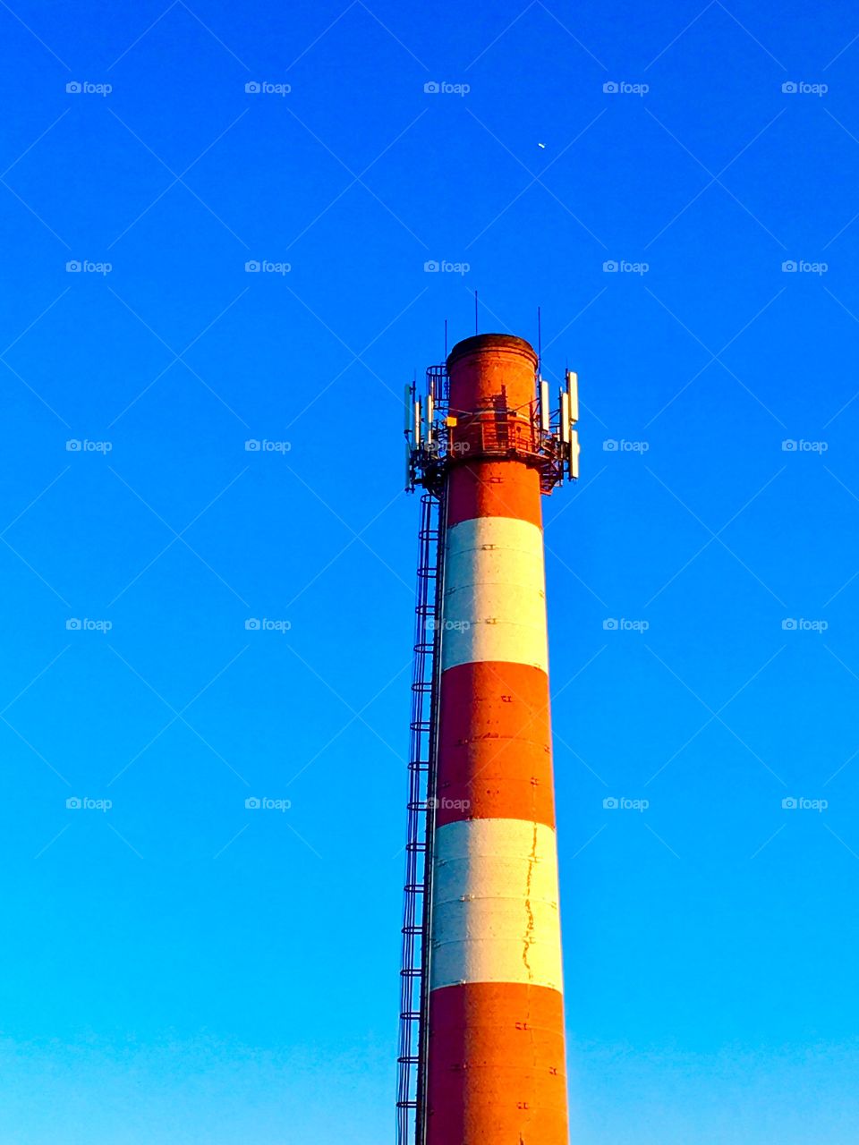 big chimney against the blue cloudless sky