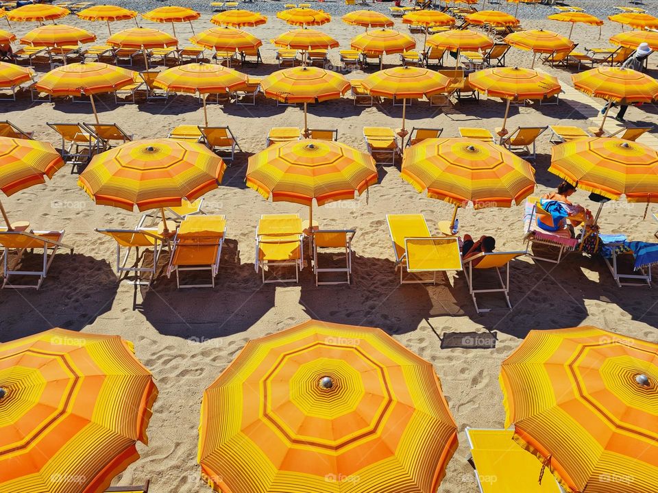 top view photo of orange sea and beach umbrellas