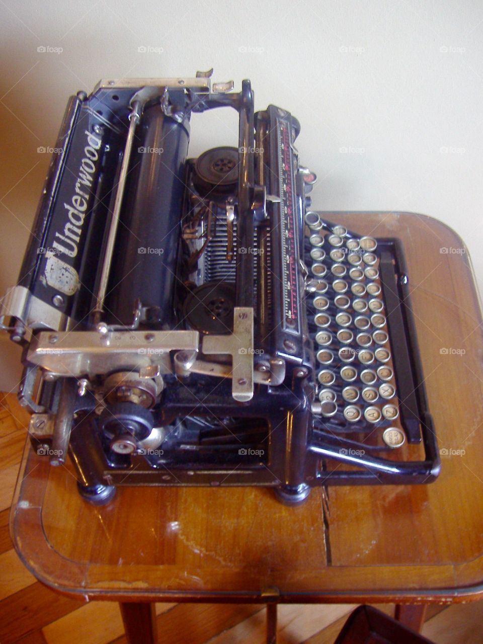 Underwood typing machine on a stand side view