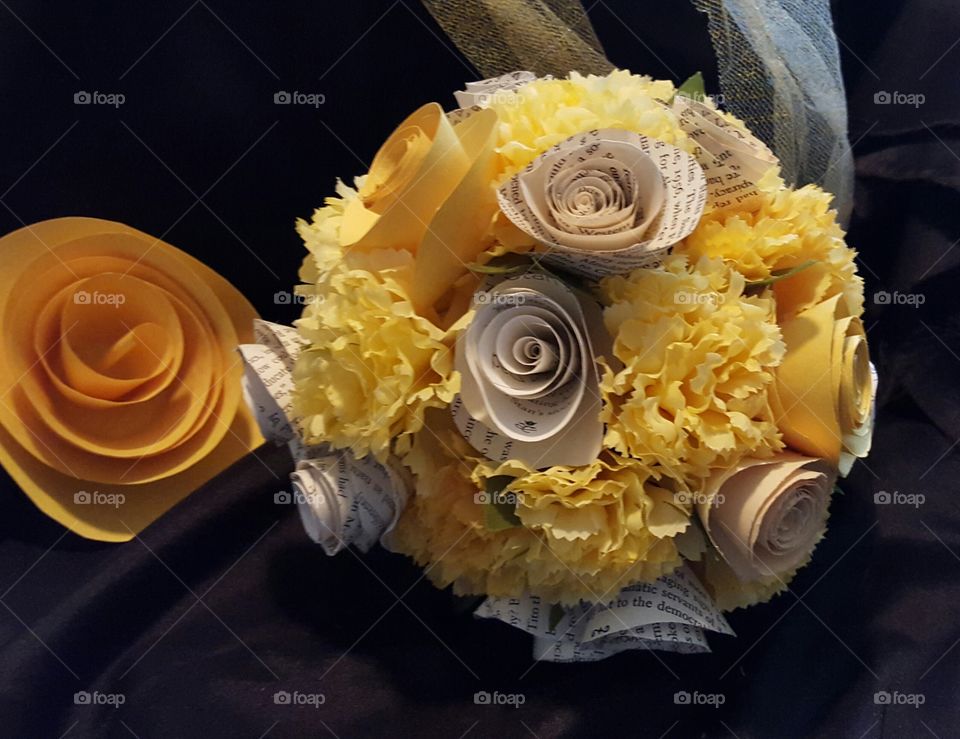 a yellow flower bouquet with paper roses