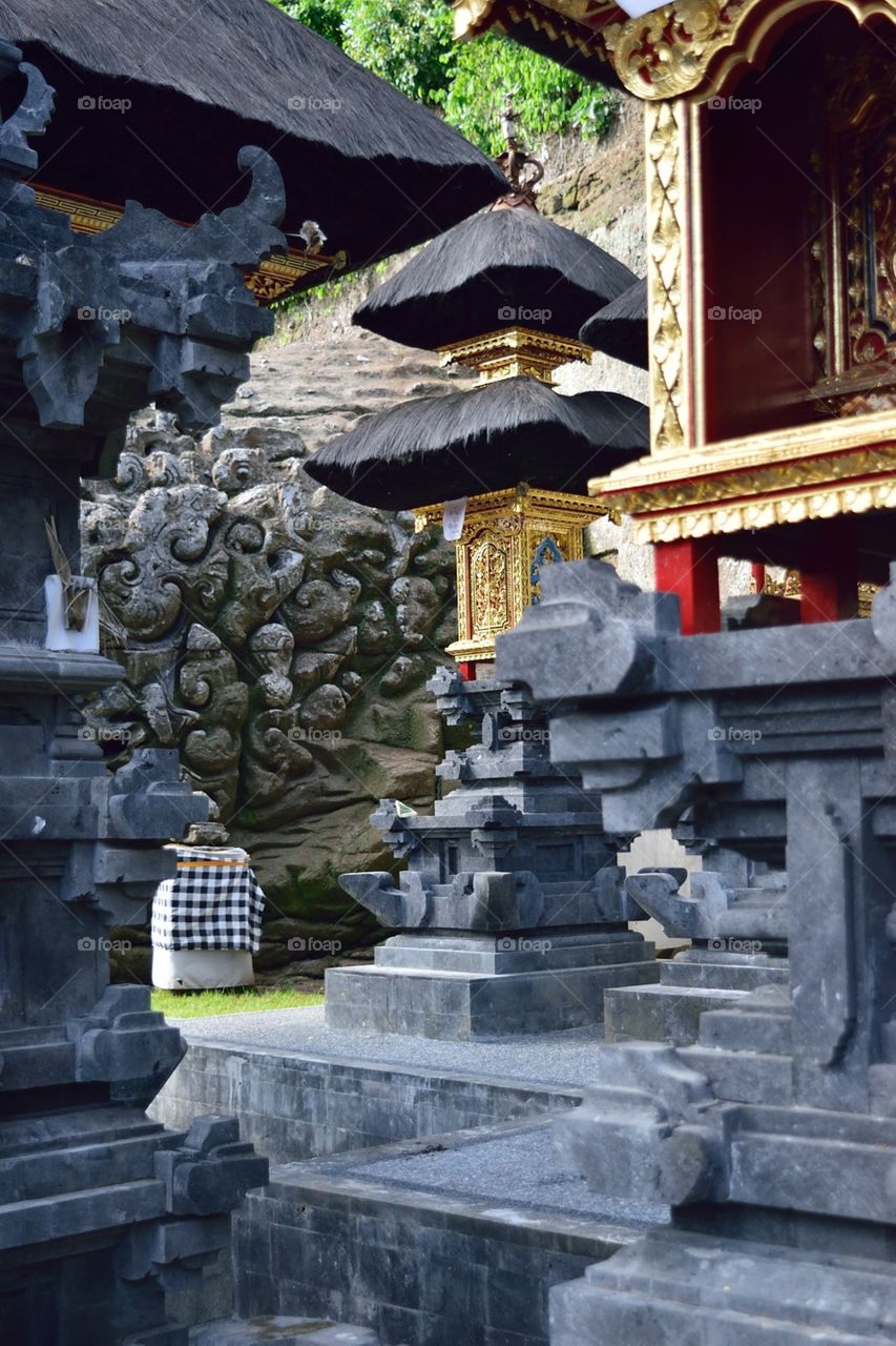 Traditional Stones and gold shrines at GoaGajah, Bali