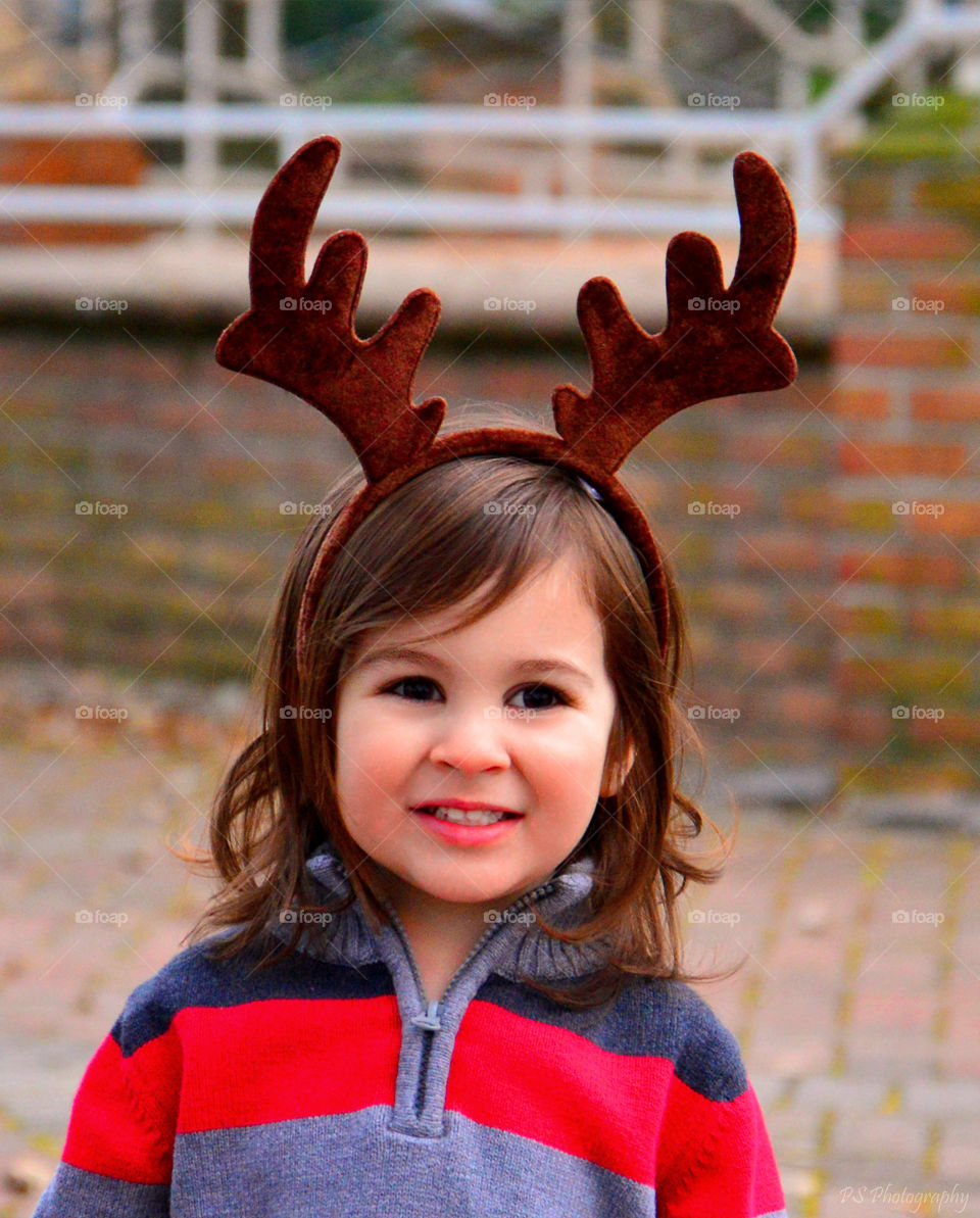 Portrait of a girl wearing reindeer headband
