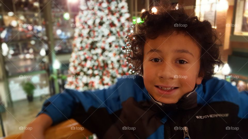 Portrait of smiling man in front of christmas tree