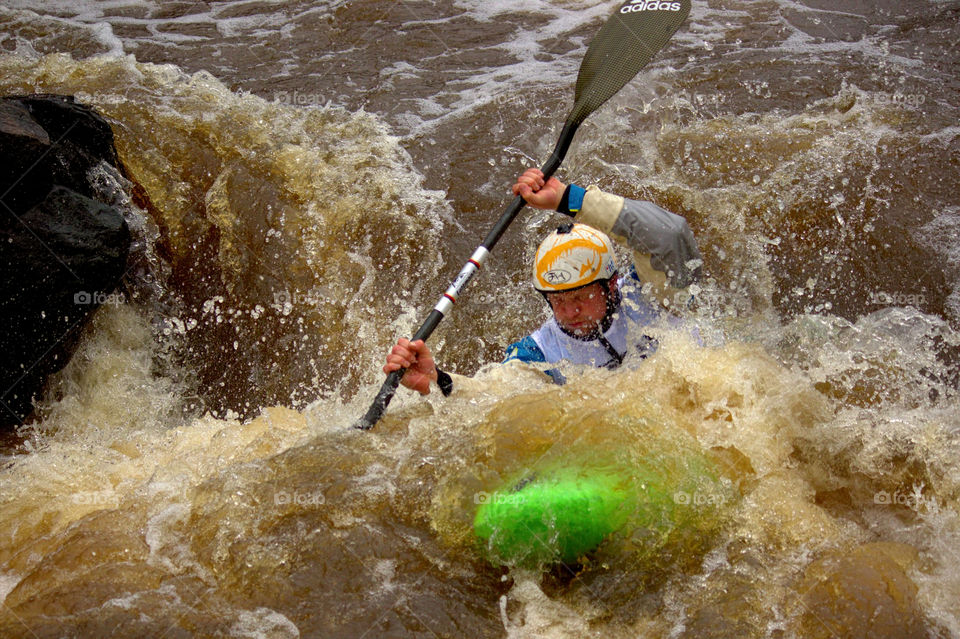 Helsinki, Finland - April 17, 2016: Unidentified racer at the annual iceBREAK whitewater kayaking competition at the Vanhankaupunginkoski rapids in Helsinki, Finland.