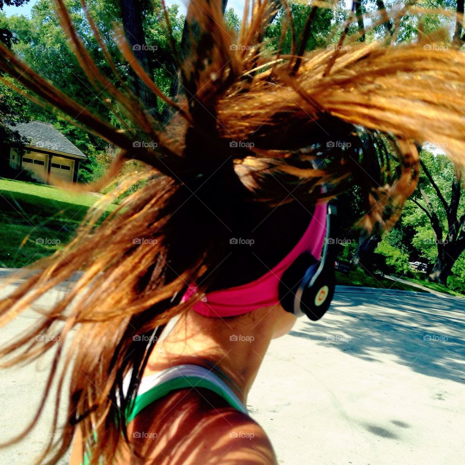 Girl running ponytail headphones