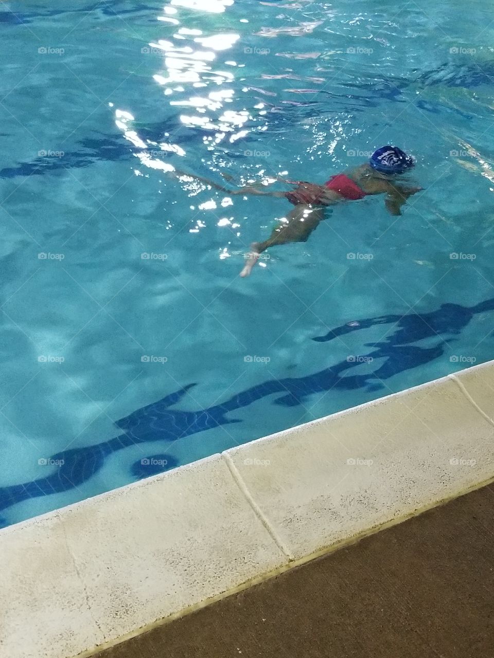 Girl swimming underwater in a two piece