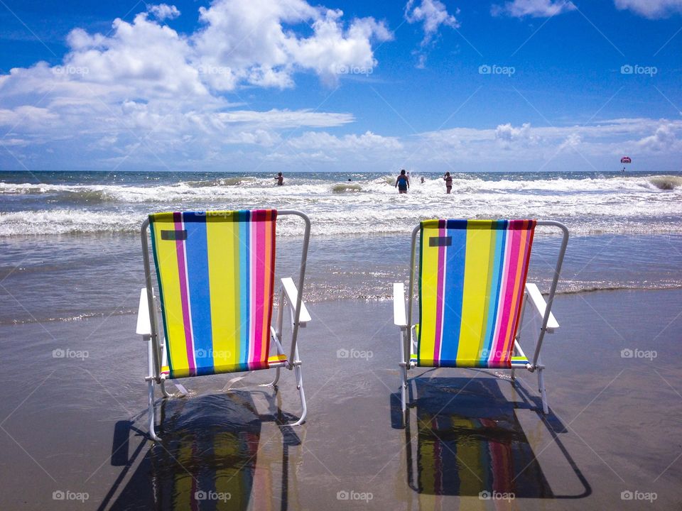 Beach chairs. Two beach chairs sitting by the seashore in Myrtle Beach South Carolina.