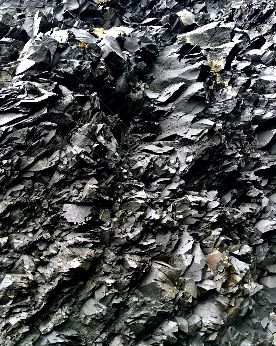 Basalt rock cliff on a black sand beach, Iceland 