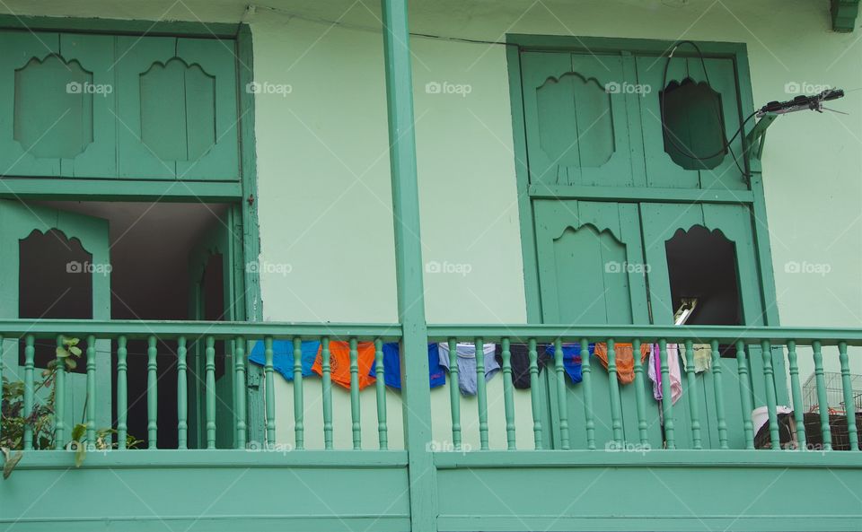Family laundry being dried on a green balcony   terrace of a home in Havana, Cuba