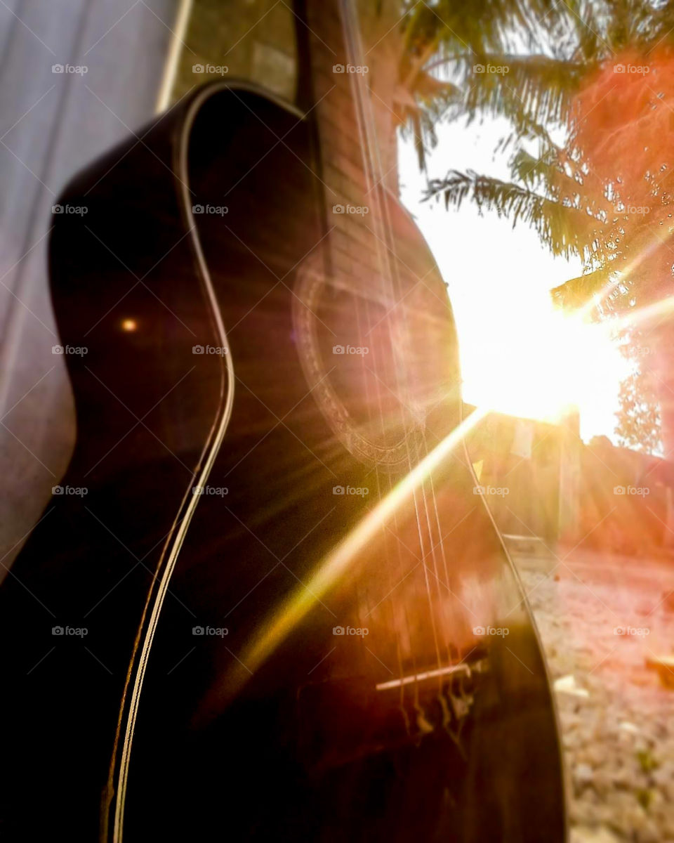 black guitar with sun rays