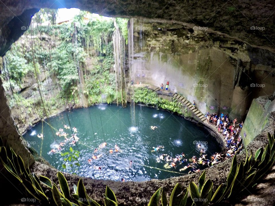 Swimming hole cistern under the ground with people swimming view from above