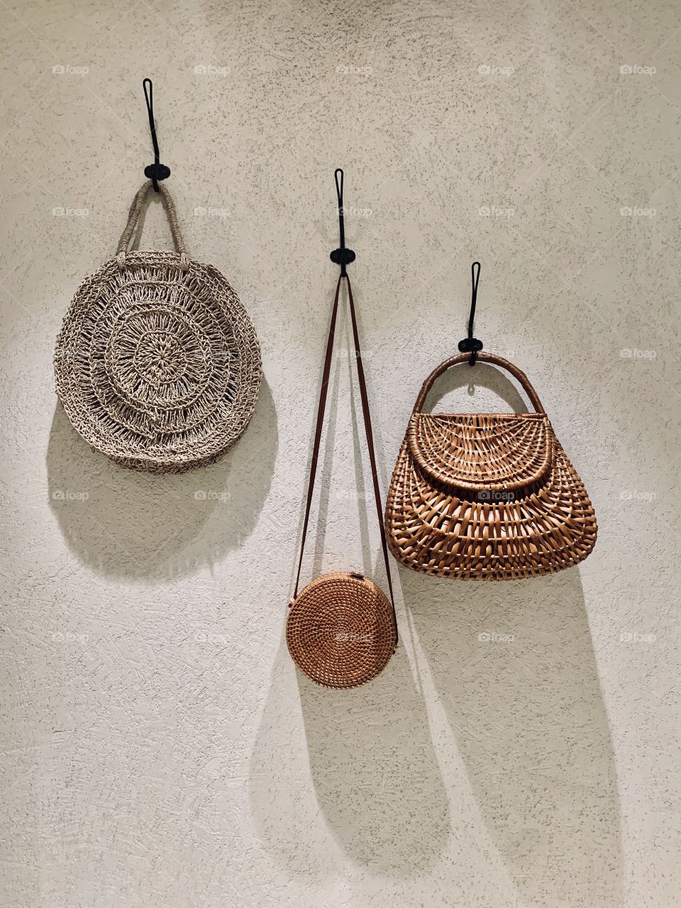 Three hanging wicker bags, fashion accessories concept 