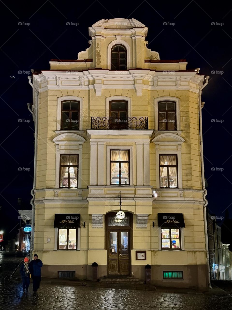 yellow house with illuminated windows