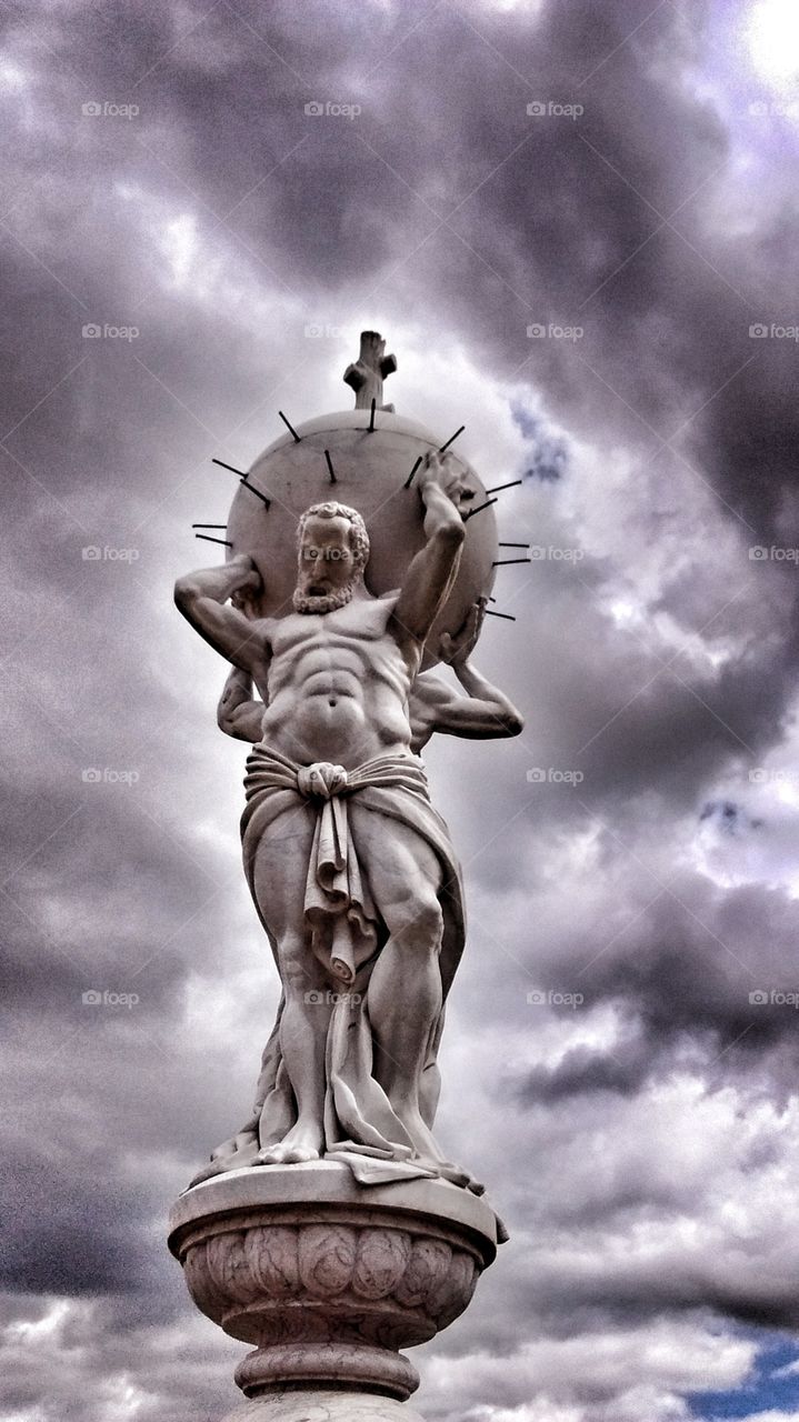 strong man statue. statue of strong men lifting heavy ball