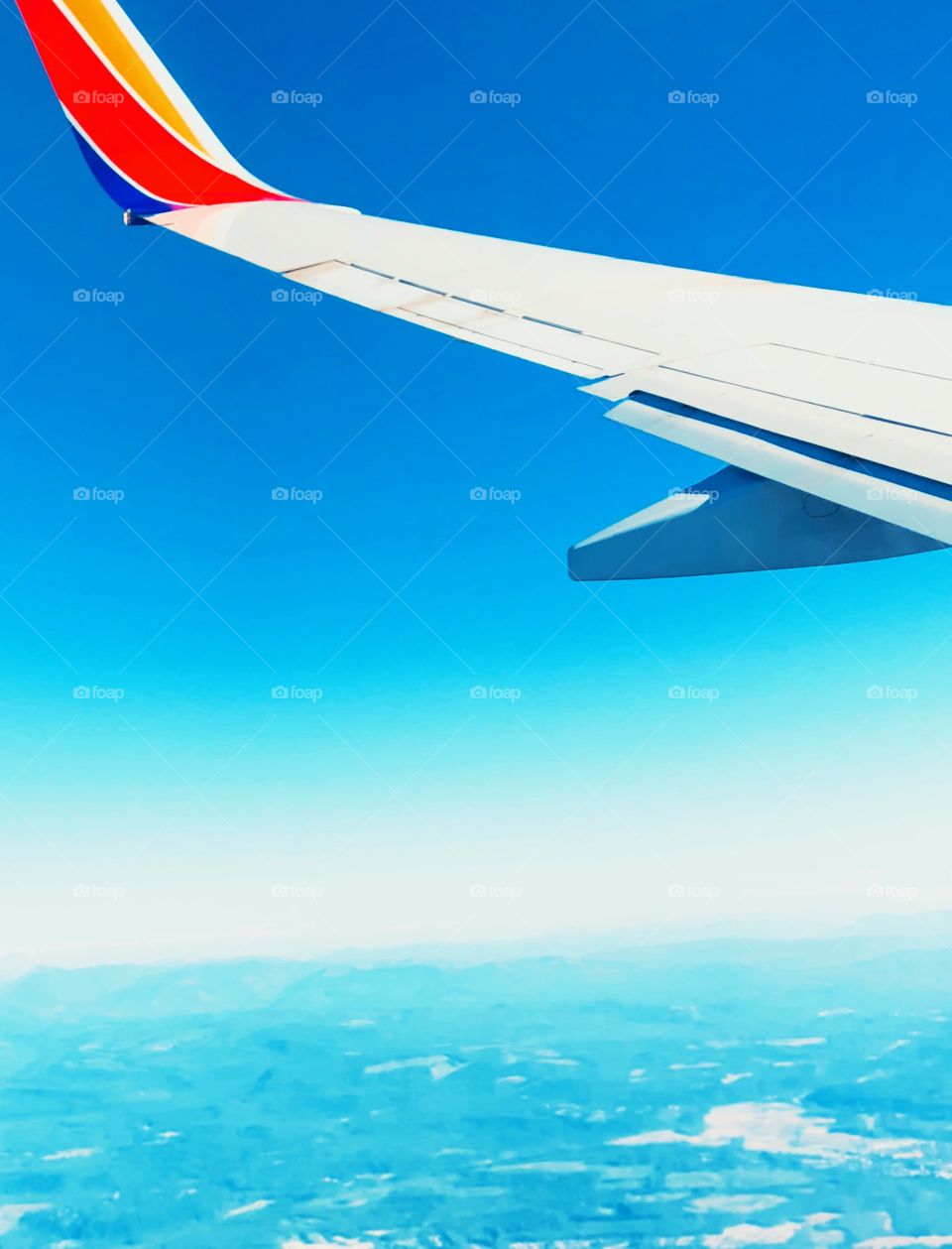 Plane window view, traveling in a plane, view from the air, bright colors outside a window, window views, traveling in the world