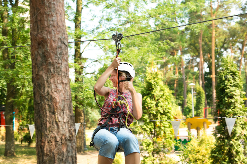 Woman tourist wearing casual clothing on zip line