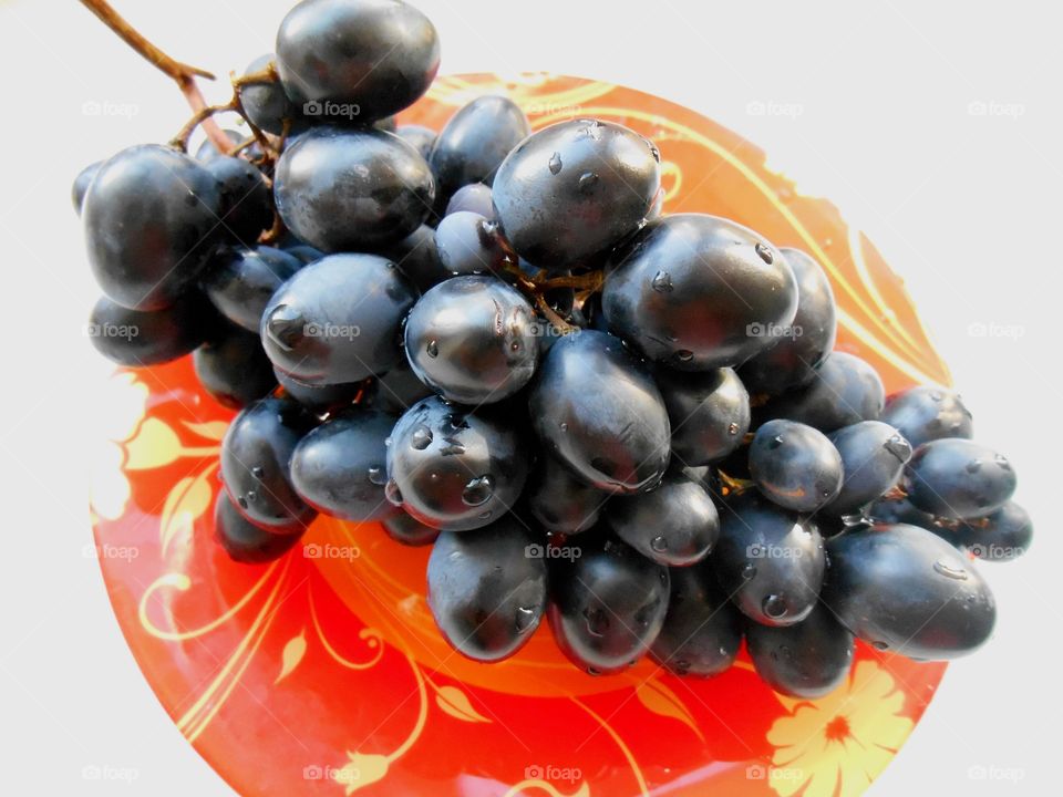 fresh dark blue grapes on a plate