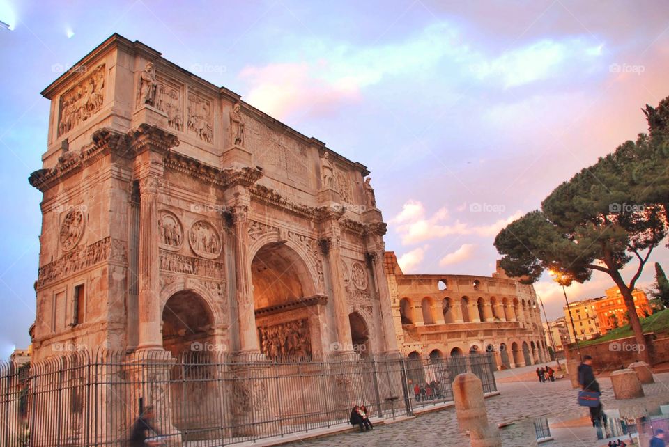 Arch of Constantine. The Arch of Constantine at sunset with the Colosseum behind if