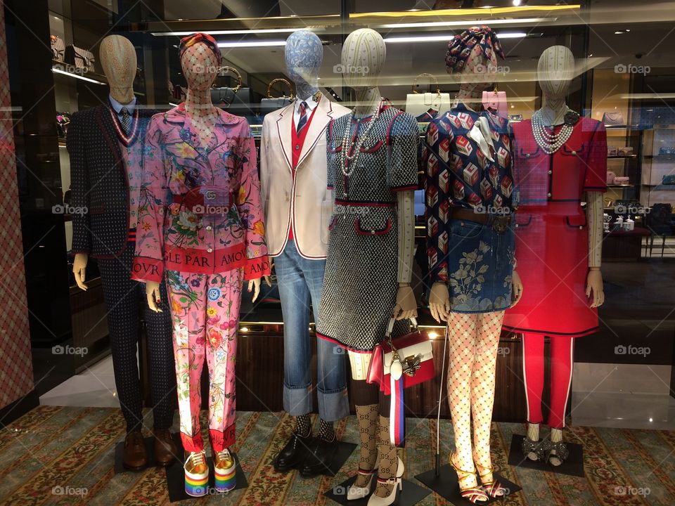 Amazing window display of men and women's designer outfits at the Gucci luxury boutique in the Mall of the Emirates in Dubai.