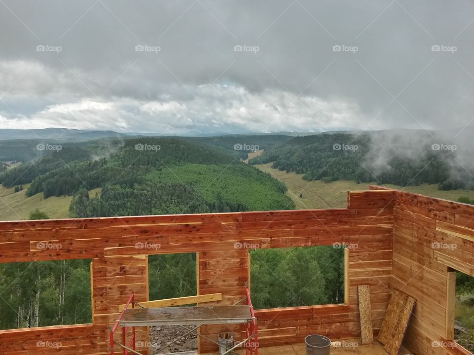 Cabin construction with a storm blowing in