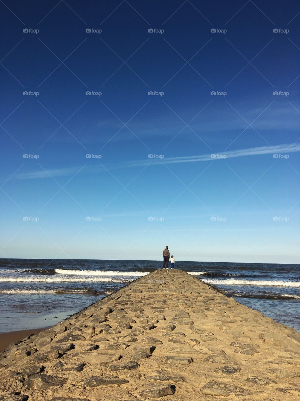 Saltburn yesterday ... late September sunshine ... blue sky day ... small stone pier with a father and daughter looking at two contrails as fast planes flew by 