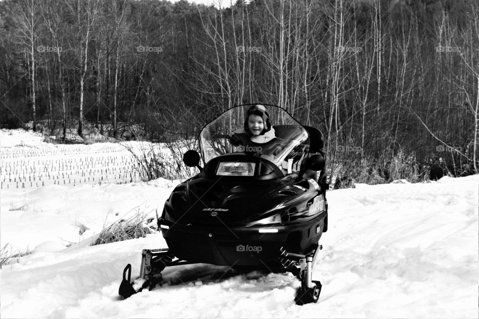 little boy on snowmobile