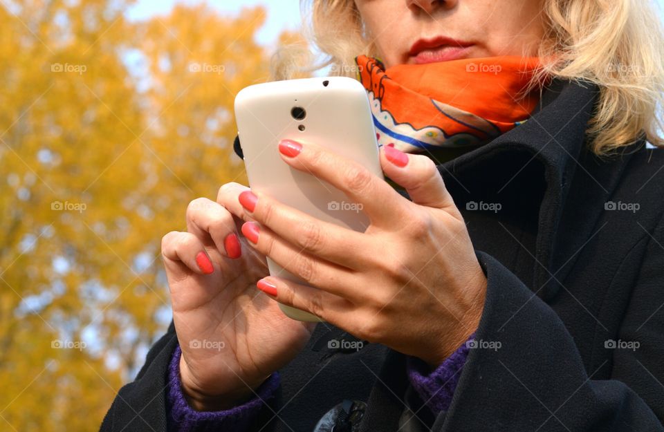 smartphone in the female hands work outdoor autumn time