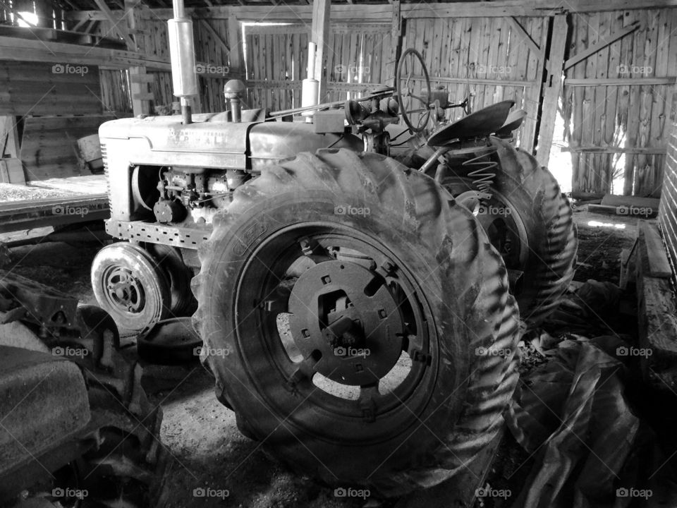 Country life, old tractor in a barn.