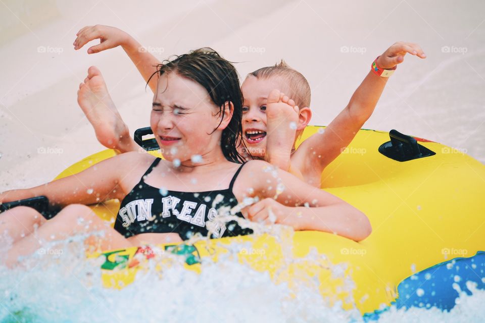 Children going down a water slide