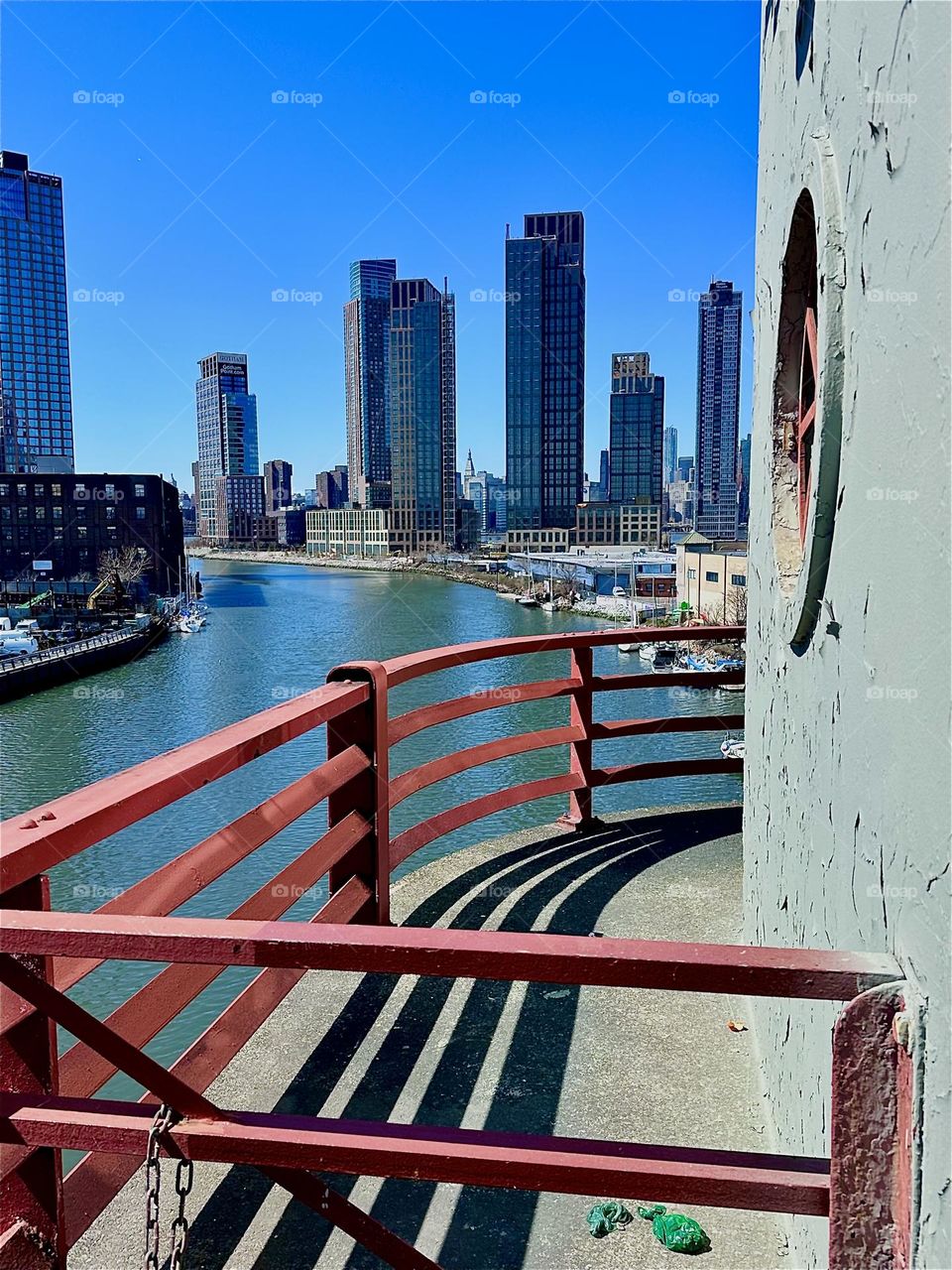This is the central outpost of the “Pulaski Bridge” at “Newtown Creek” that connects LIC, Queens to “Greenpoint”, Brooklyn. In the distance behind the LIC high rises we see “Manhattan”. 2024. Hypnotic Productions