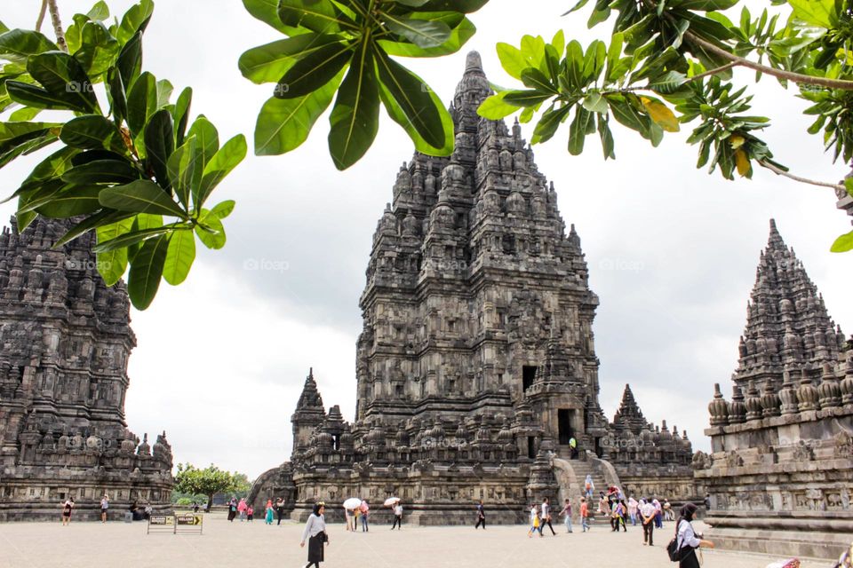 One of the temples in the Prambanan Temple Complex, with a stone relief on the wall of the temple which is part of the largest Hindu temple in Southeast Asia, Yogyakarta, Indonesia - June 23, 2023